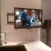 Wall Mounted TV installation with motorized articulating arm controlled by remote